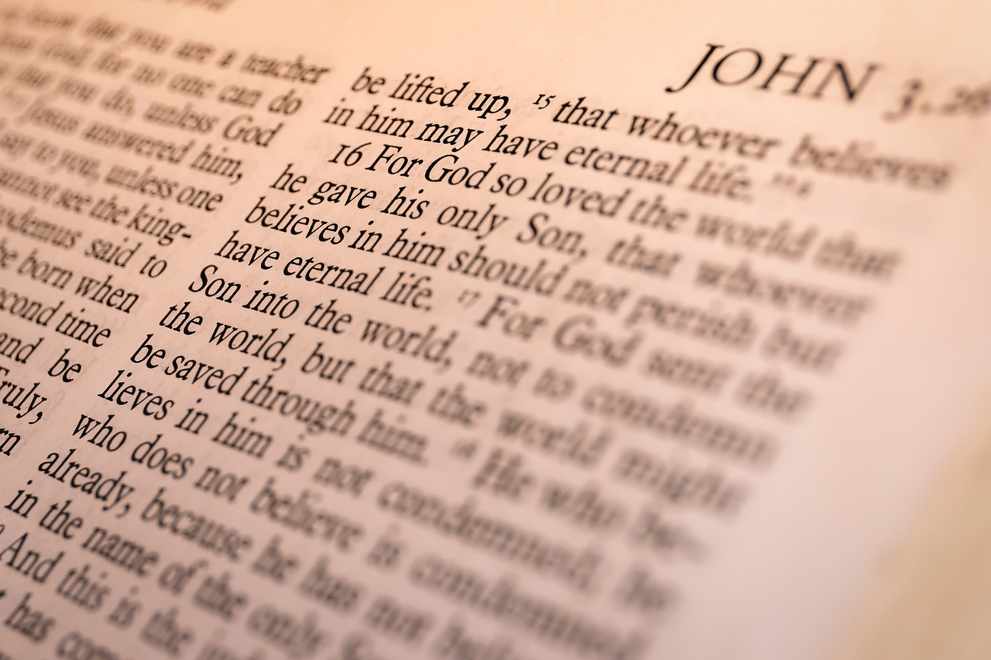 A close up of the word john in an old bible